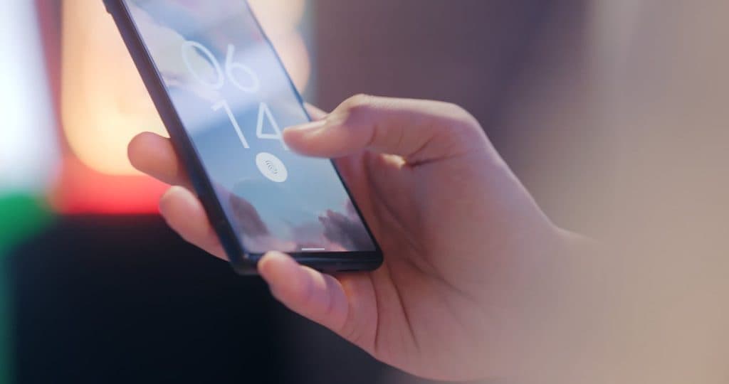 Image showing user trying to unlock phone using fingerprint sensor