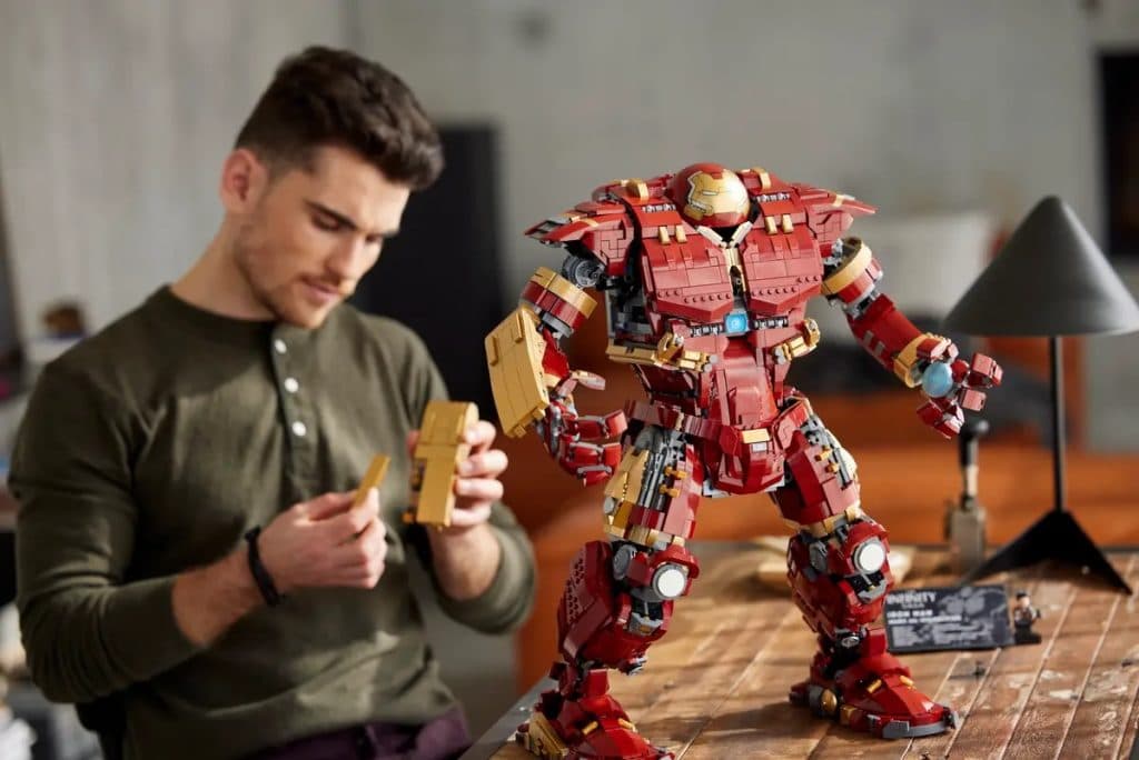 An adult with the LEGO Marvel Hulkbuster