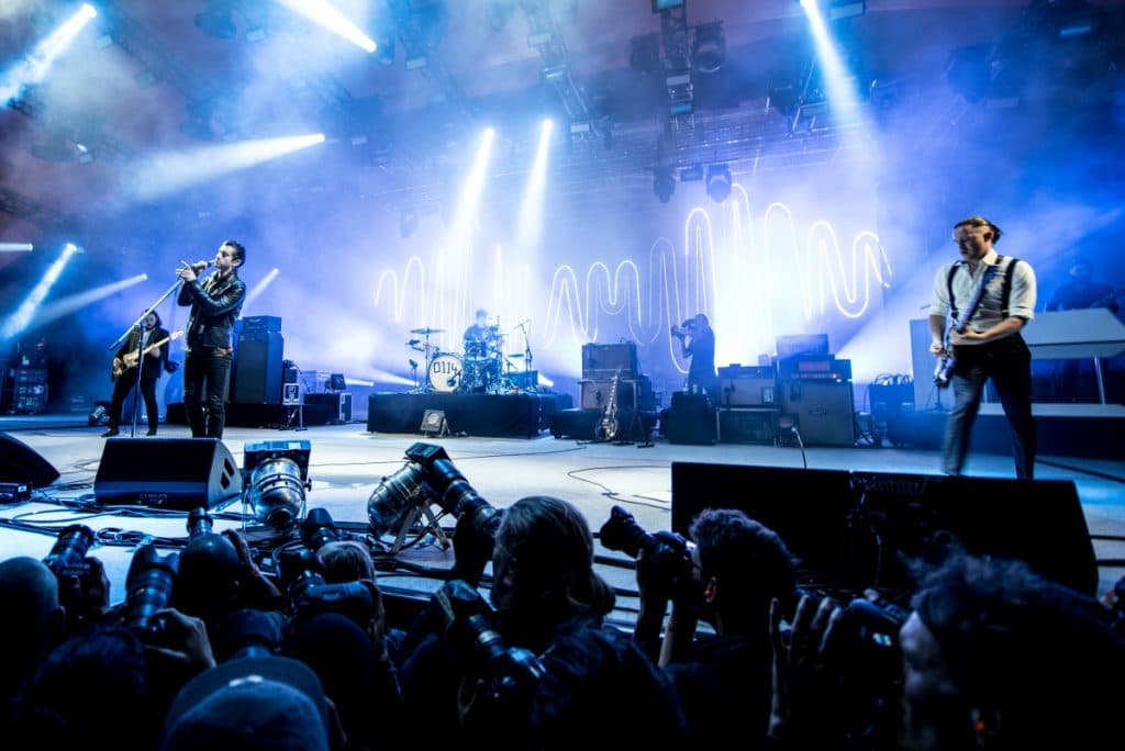 Arctic Monkeys performing onstage during a tour