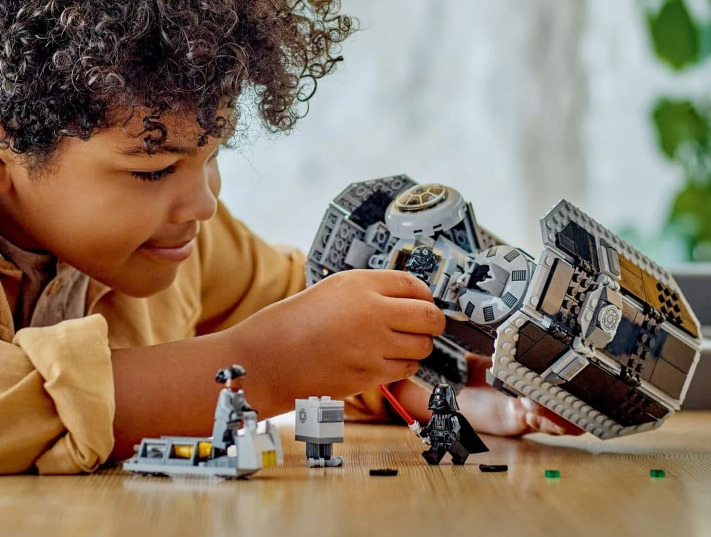 A child playing with their LEGO Star War TIE Bomber Starfighter