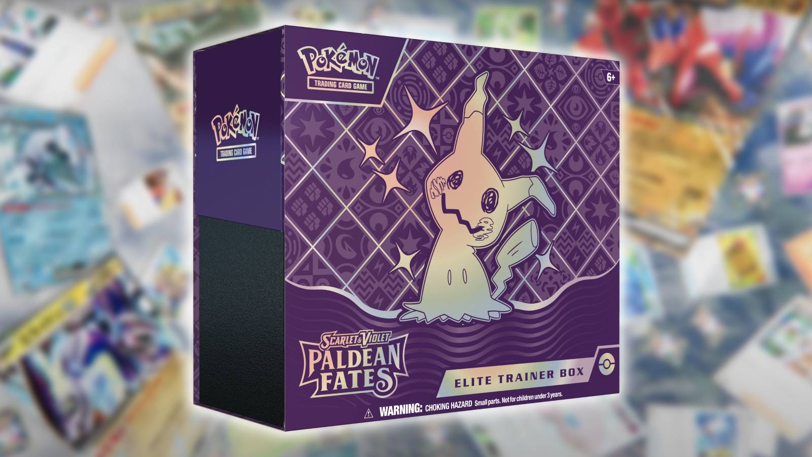 The Pokemon TCG Paldean Fates Elite Trainer Box is visible against a blurred background