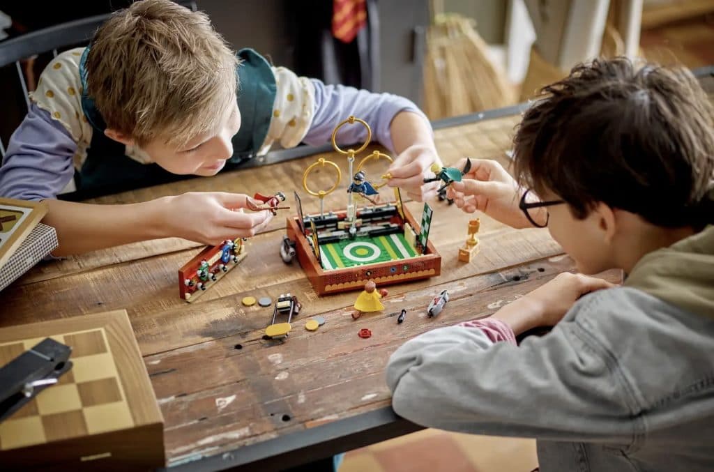 Two children challenge each other to a fun game of LEGO Quidditch.