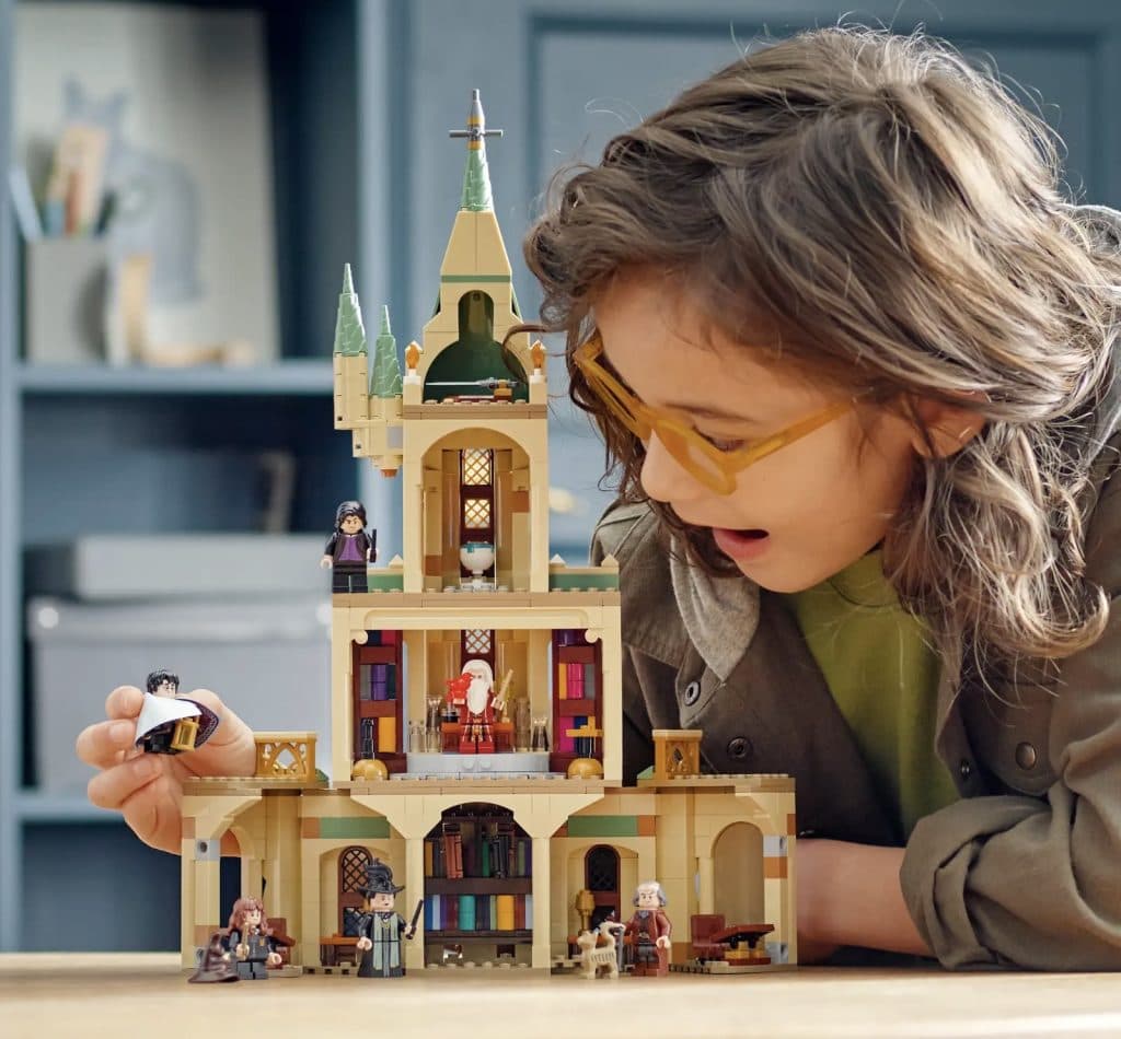 A child loving the experience of playing with the LEGO-reimagined Dumbledore's Office.