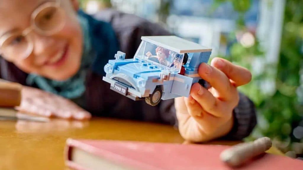 A child playing with the LEGO Harry Potter flying Ford Anglia.