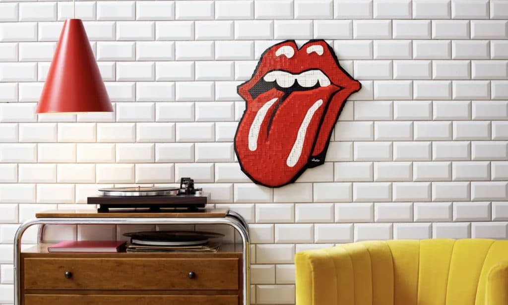 The LEGO-reimagined The Rolling Stones logo displayed on a wall next to a turntable.
