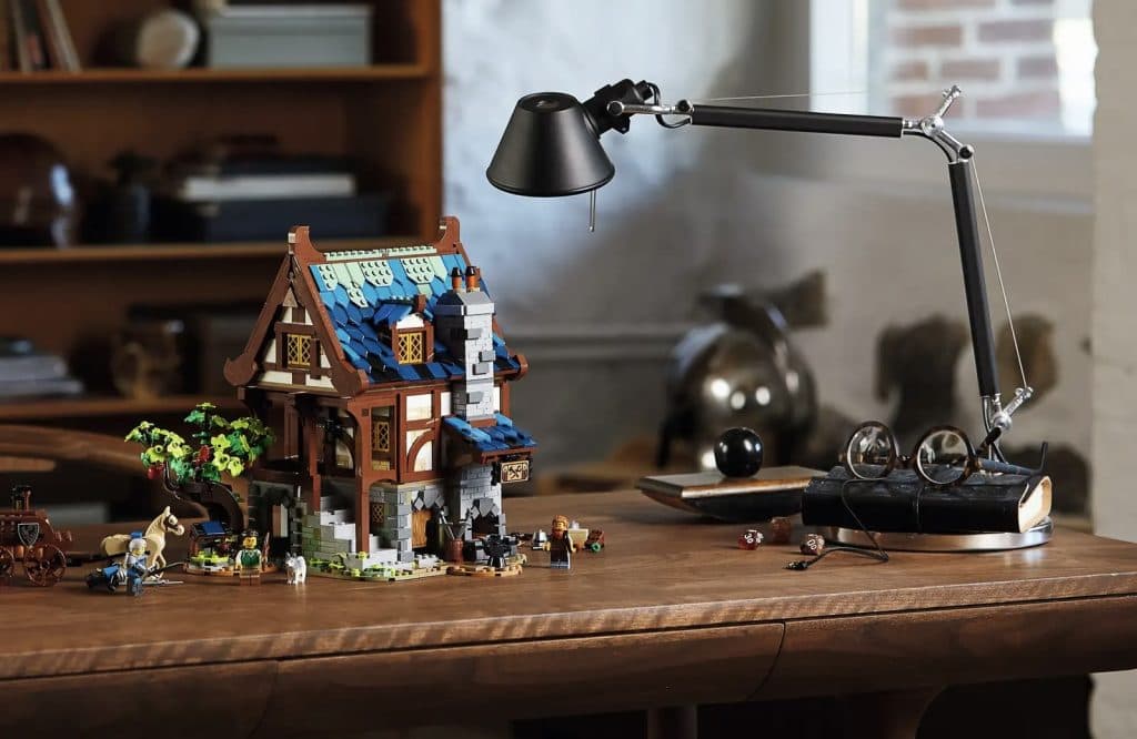 LEGO-reimagined Medieval Blacksmith set displayed on a desk.
