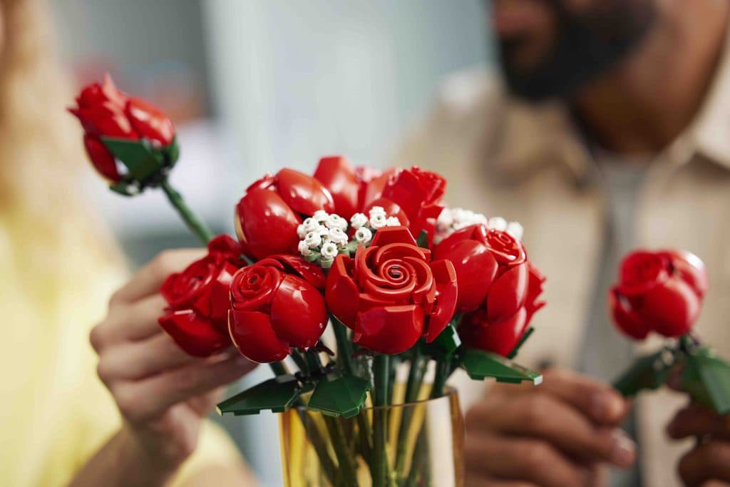 A LEGO builder completes the bouquet of rose-inspired LEGO.