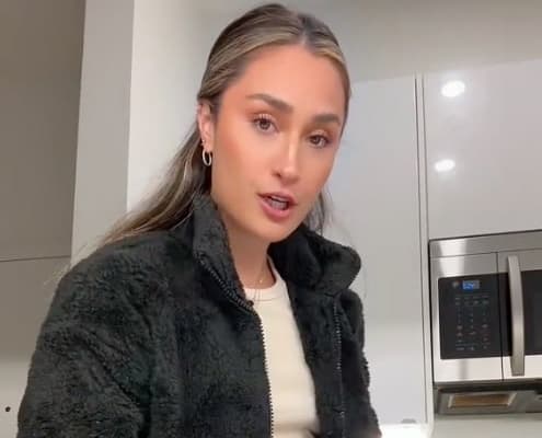 Woman looks into camera while filming a TikTok video