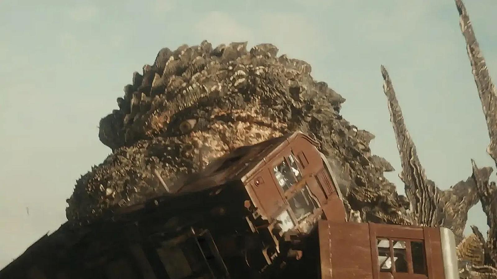 Godzilla bites a tram in Godzilla Minus One