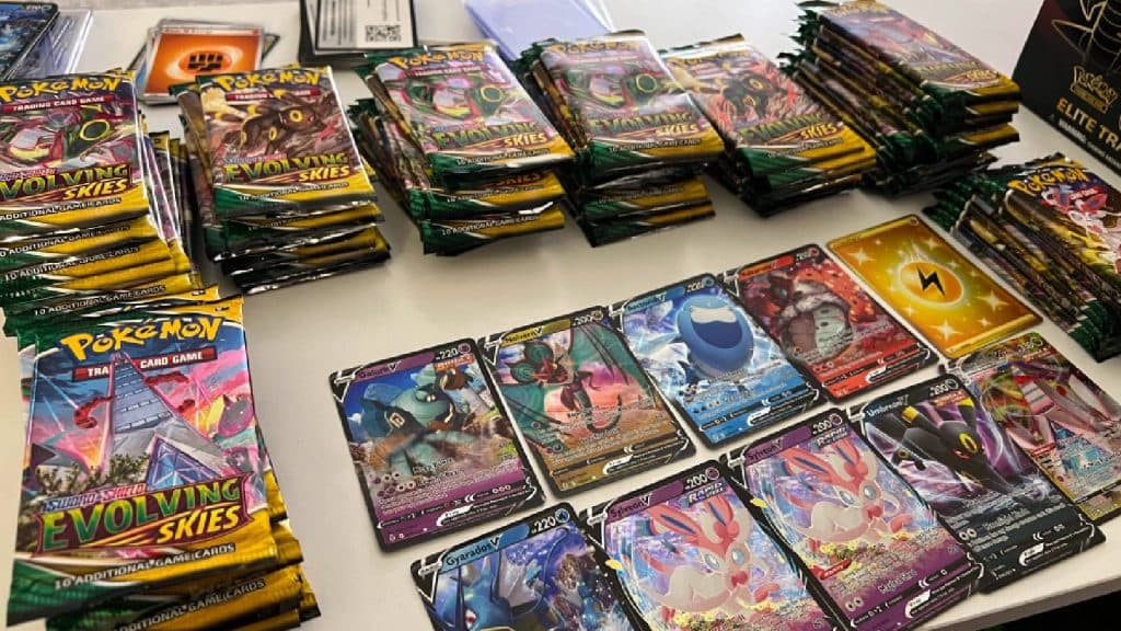 A selection of Pokemon TCG cards are shown on a desk