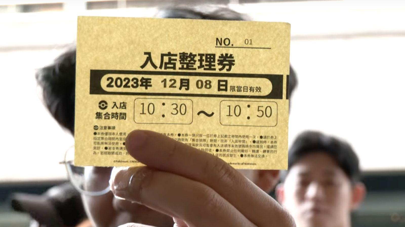 Man holding Pokémon Center Taipei lottery ticket