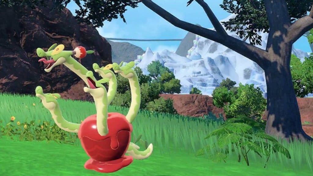 The Pokemon hydrapple pokes several heads out of a large apple