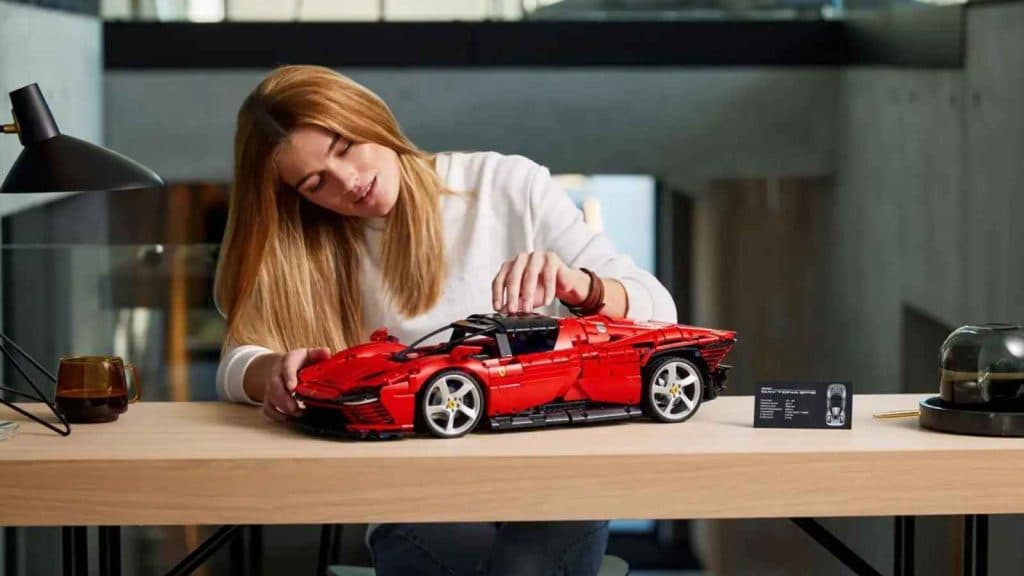 Adult with their LEGO Ferrari Daytona SP3 set.