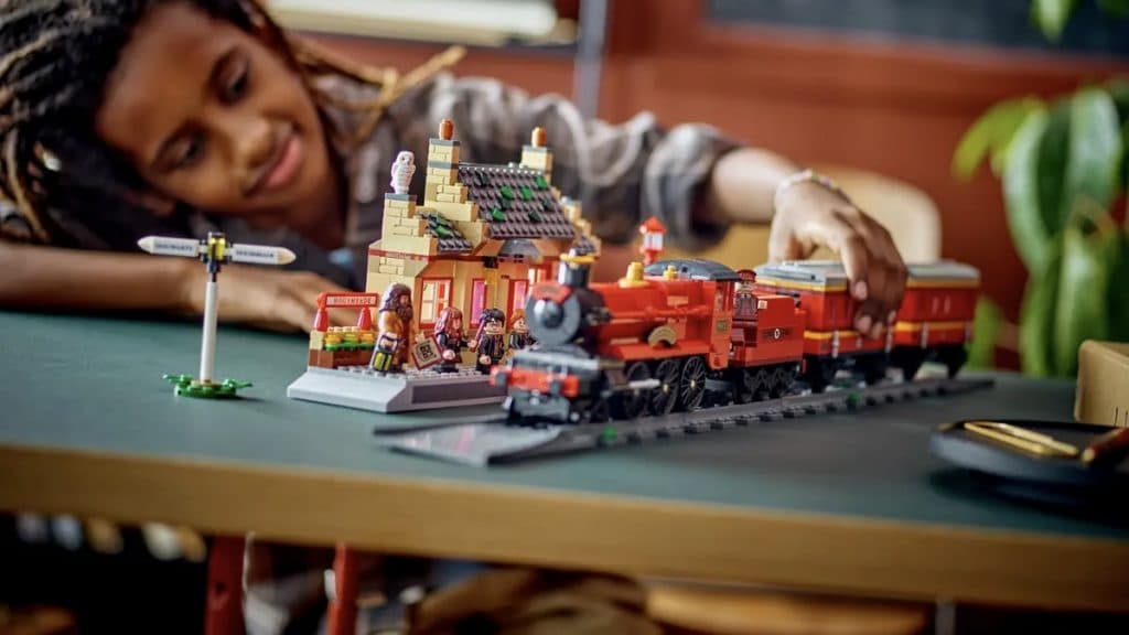 A child with their 2. LEGO Harry Potter Hogwarts Express Train Set with Hogsmeade Station set