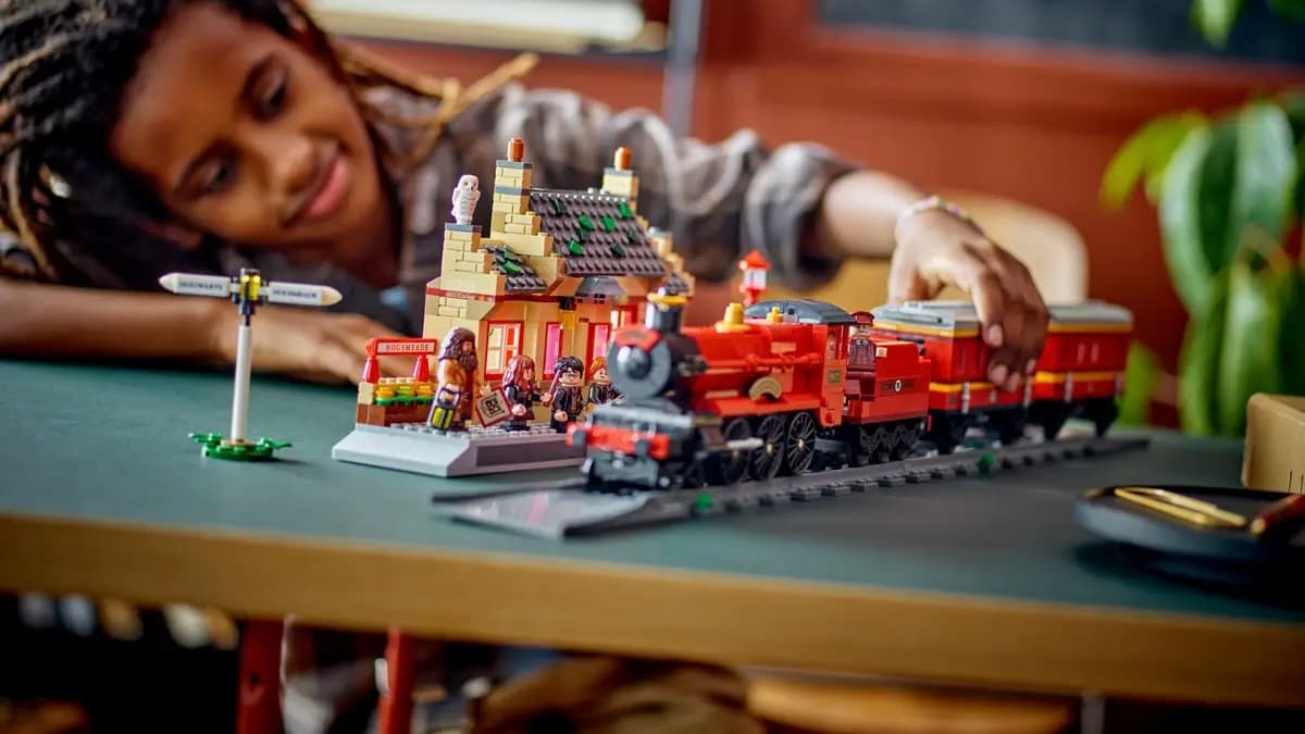 A child with their 2. LEGO Harry Potter Hogwarts Express Train Set with Hogsmeade Station set