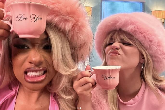 Megan Thee Stallion and Reneé Rapp drinking tea in pink outfits