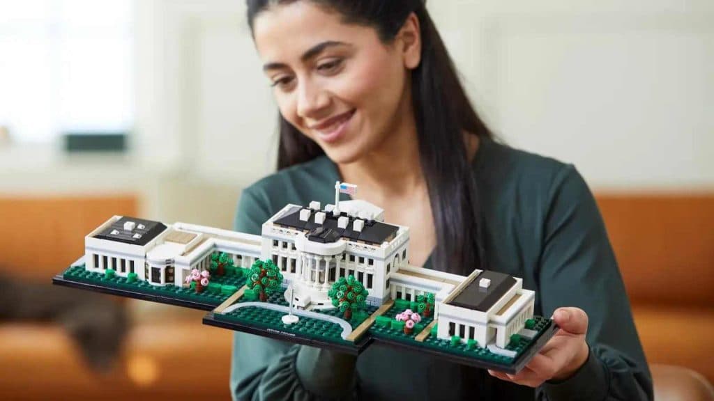 An adult admiring their LEGO Architecture The White House set.