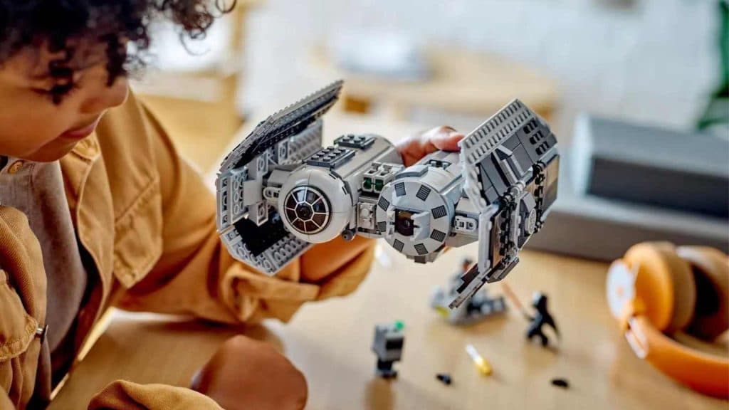 A child playing with the LEGO Star Wars TIE Bomber