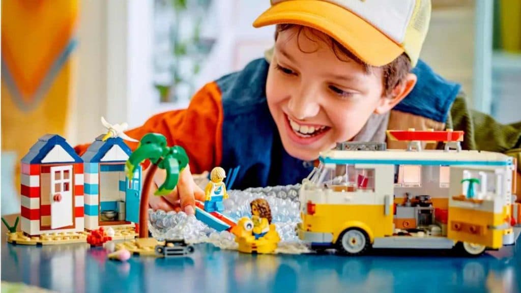 A child playing with their LEGO Creator 3in1 Beach Camper Van set