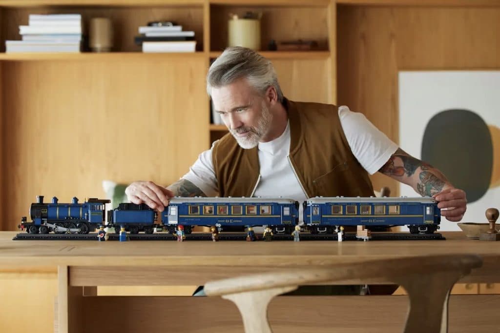 An adult admiring their LEGO Ideas The Orient Express.