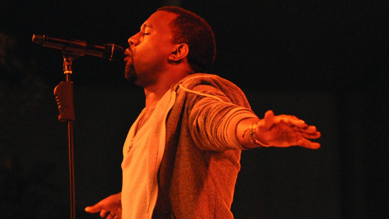 Kanye West performing onstage at a concert