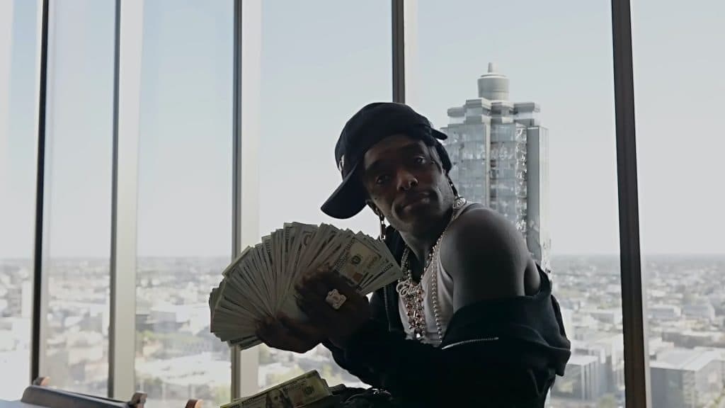 Lil Uzi Vert holding up a handful of cash