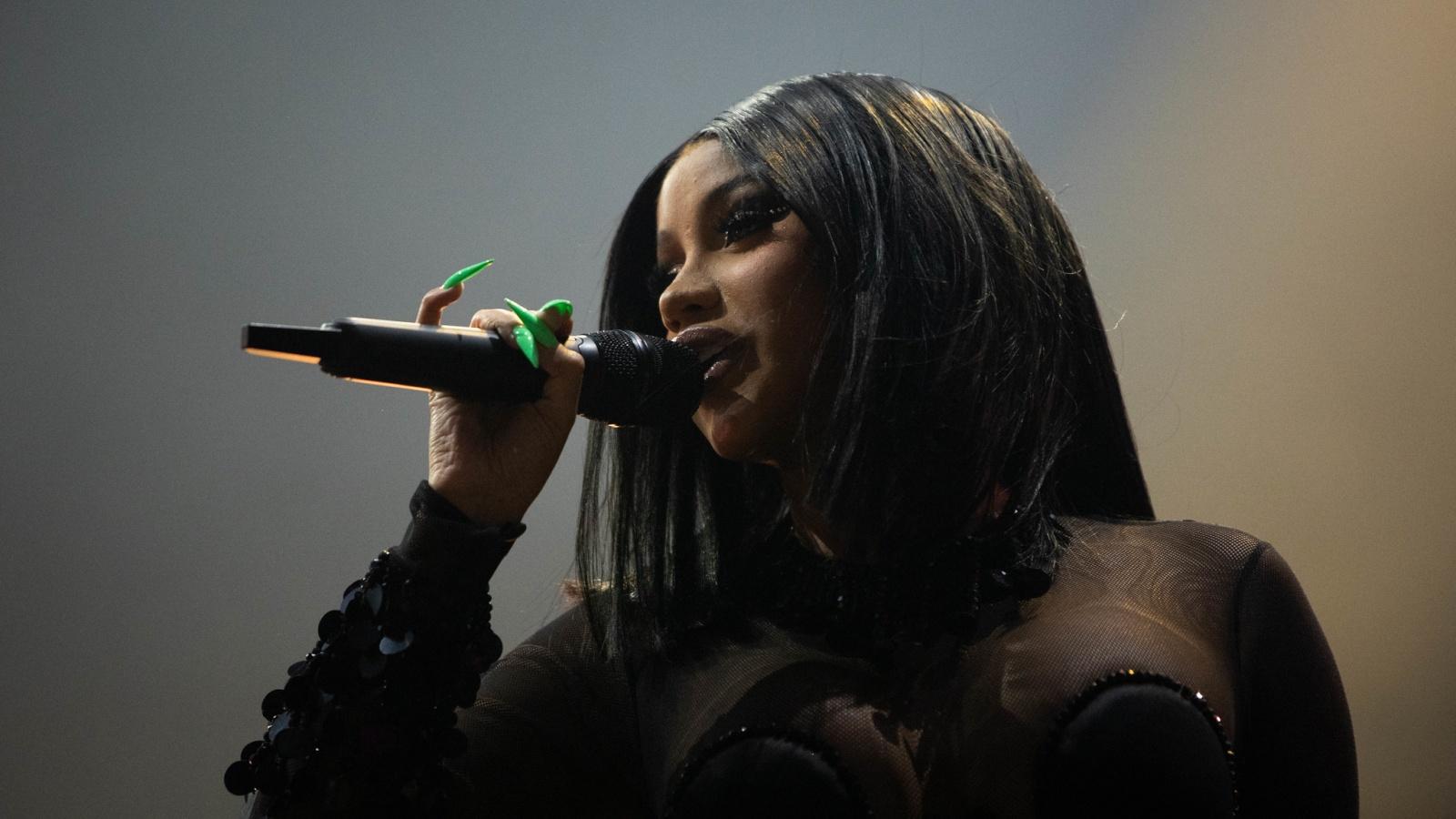 Cardi B performing onstage at a festival concert