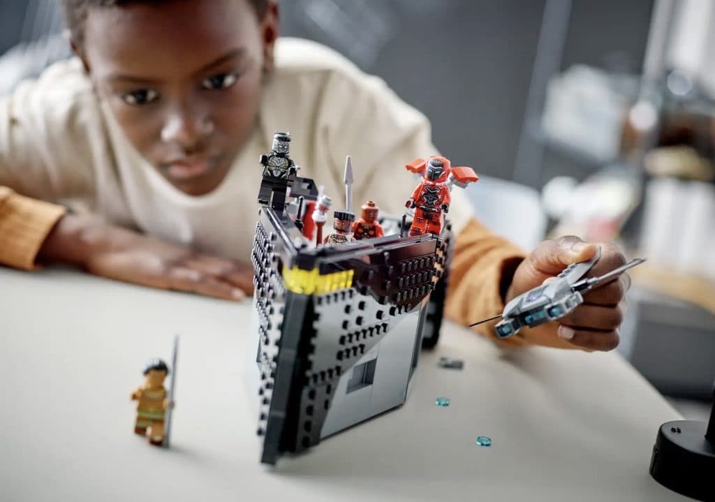A child playing with their LEGO Marvel Black Panther: War on the Water set.