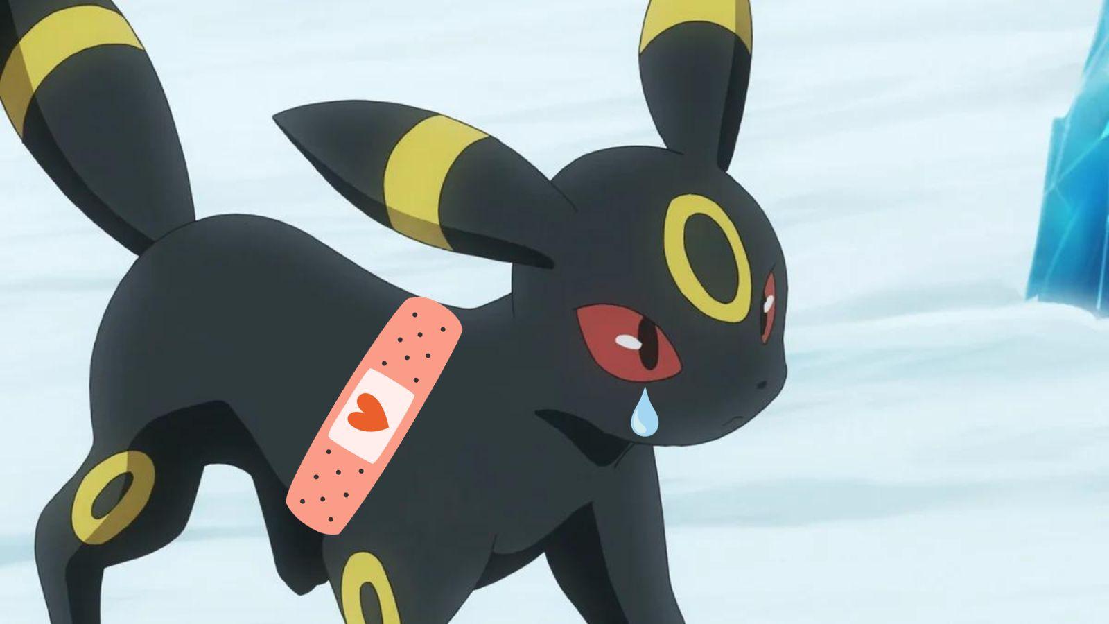 The Pokemon, Umbreon, on the snow with a plaster crying a tear