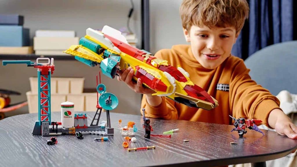 A child playing with their LEGO Monkie Kid's Galactic Explorer.