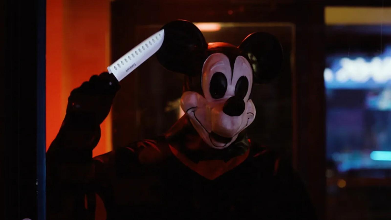Mickey Mouse holding a knife.