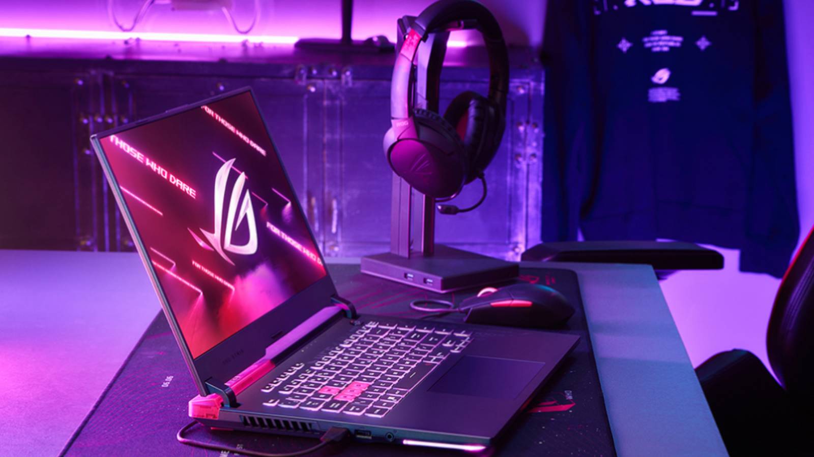 Image of the ASUS ROG Strix G15 Gaming Laptop, on a desk with a pink and purple background.