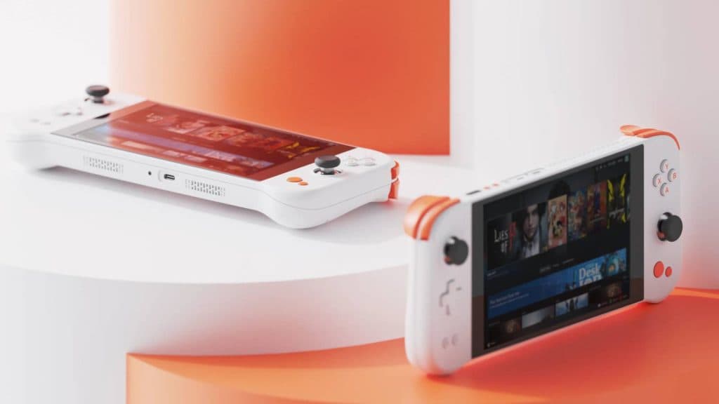 Image of two Ayaneo Next Lite handhelds, sitting on matching orange and white tabletops.