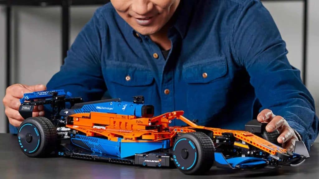 An adult admiring their LEGO Technic McLaren Formula 1 Race Car.
