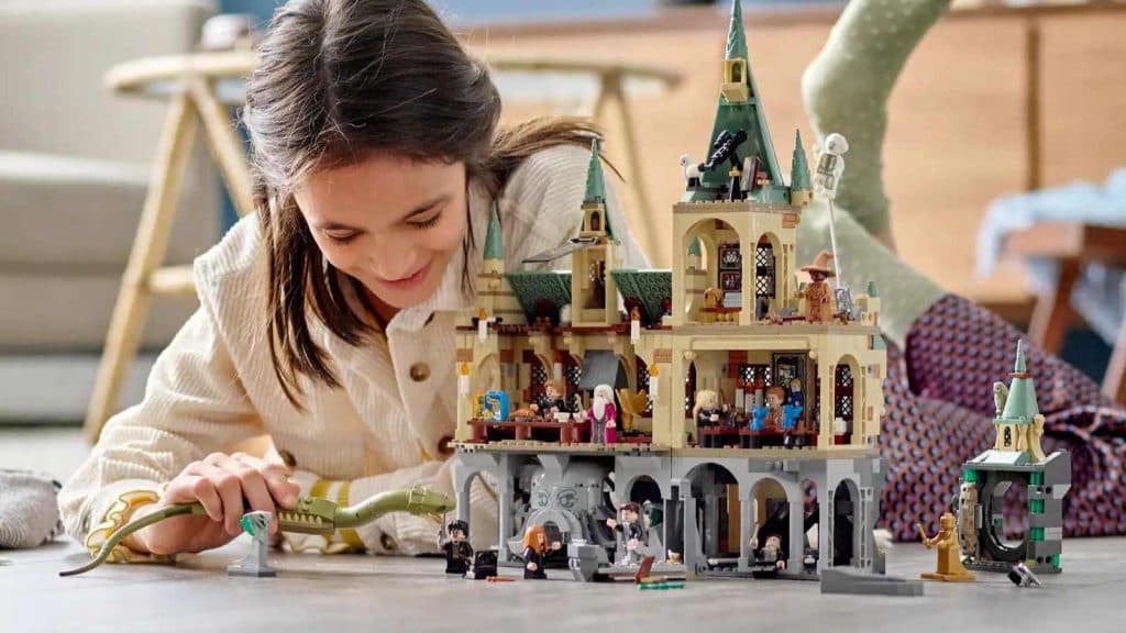A child playing with their LEGO Harry Potter Chamber of Secrets set