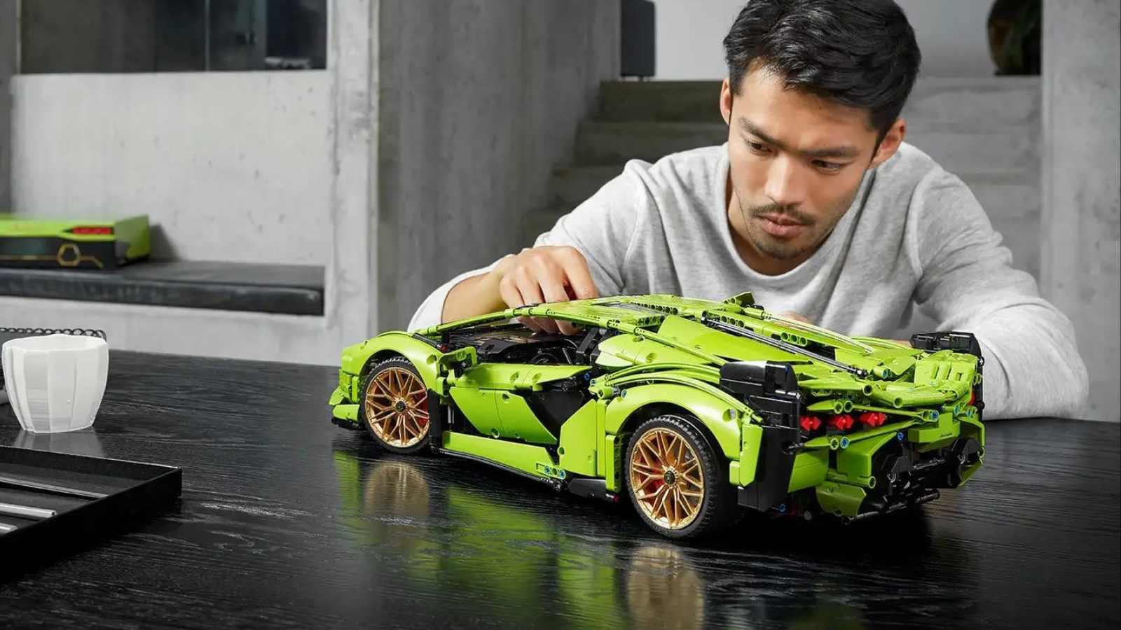 An adult admiring their LEGO-reimagined Lamborghini Sián FKP 37 set