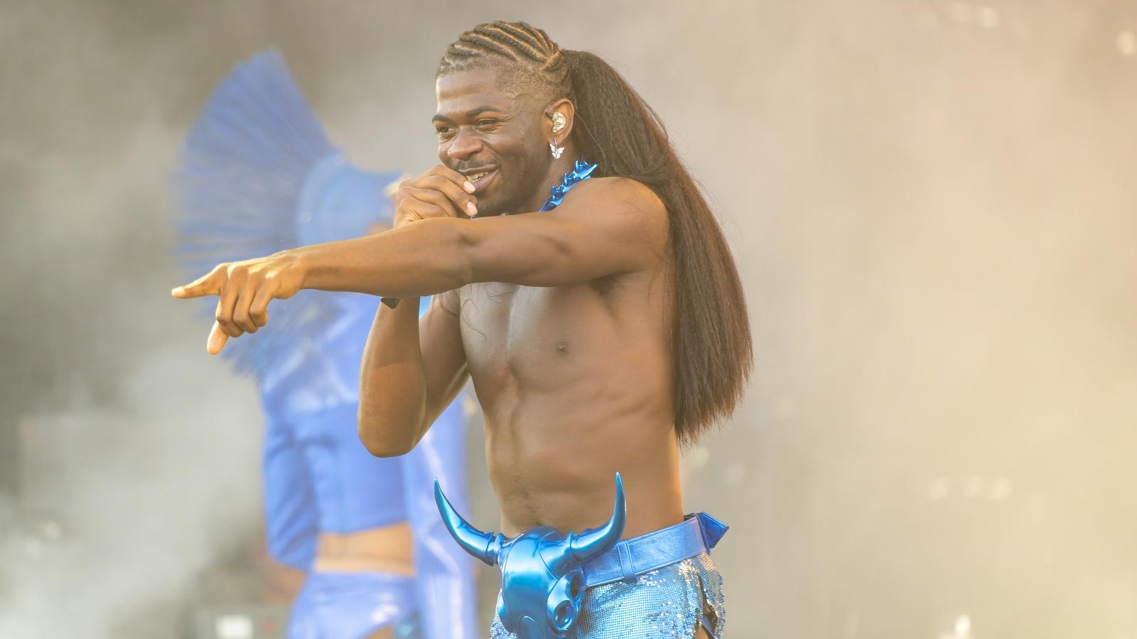 Lil Nas X performs onstage shirtless