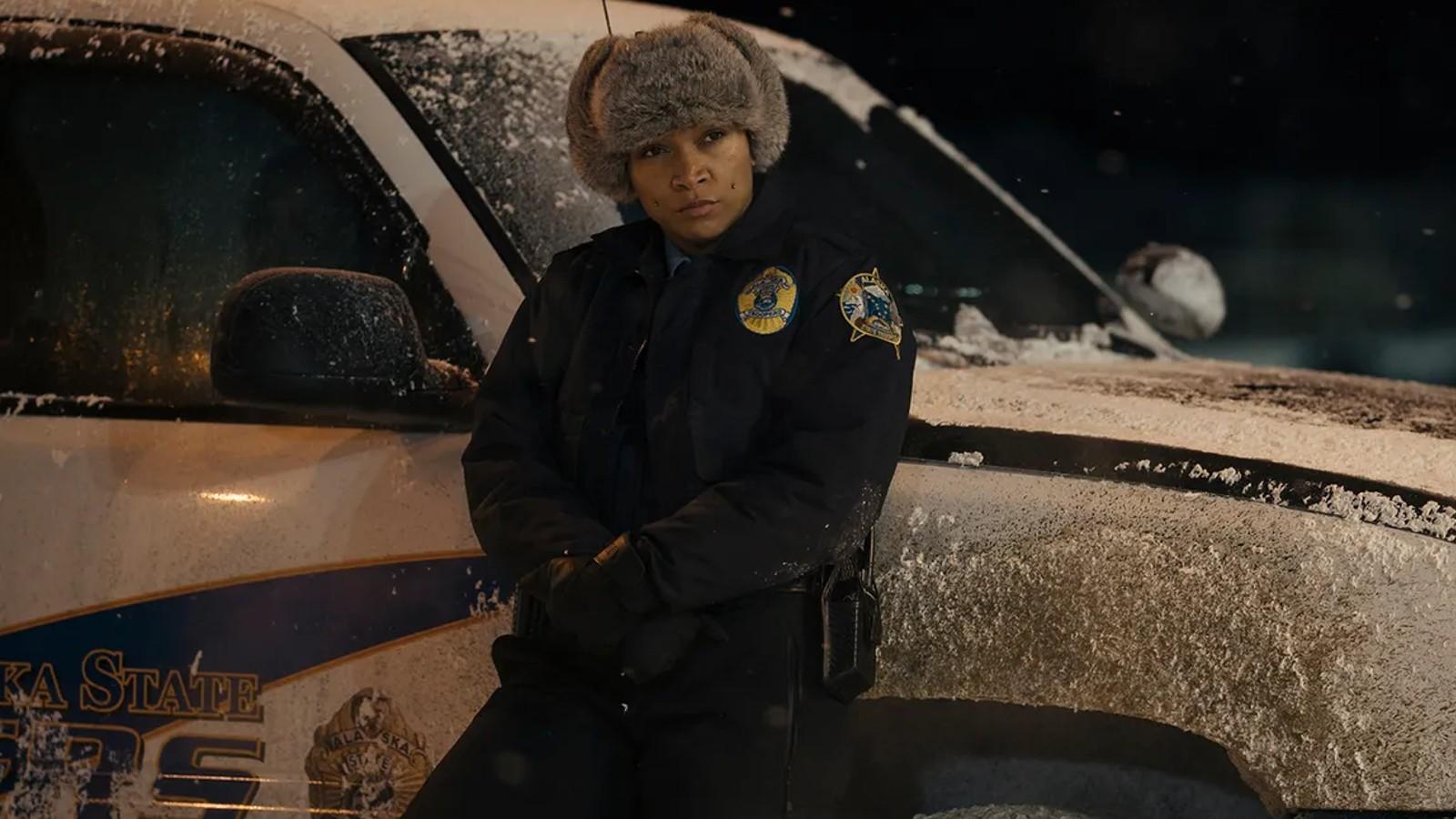 Kali Reis leaning against a police car in True Detective Season 4.