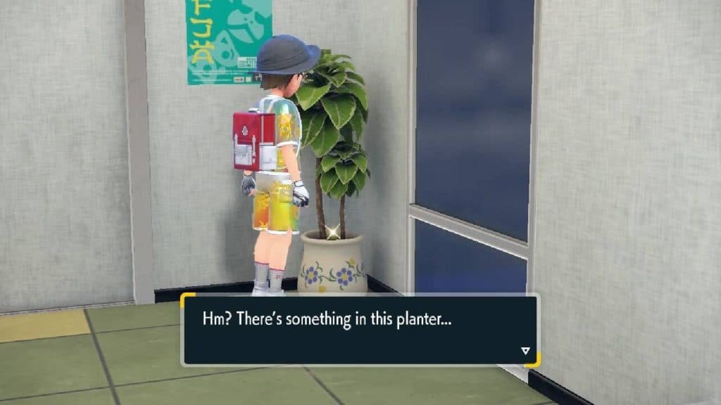 A Pokemon trainer looks at a plant pot