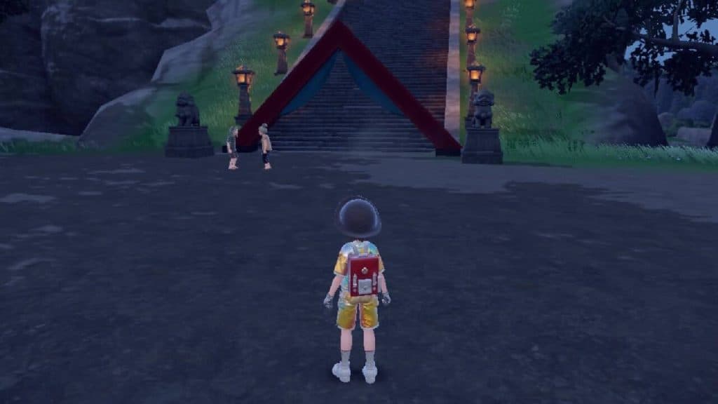The Pokemon protagonist approaches two trainers at the bottom of the steps to Kitikami Hall