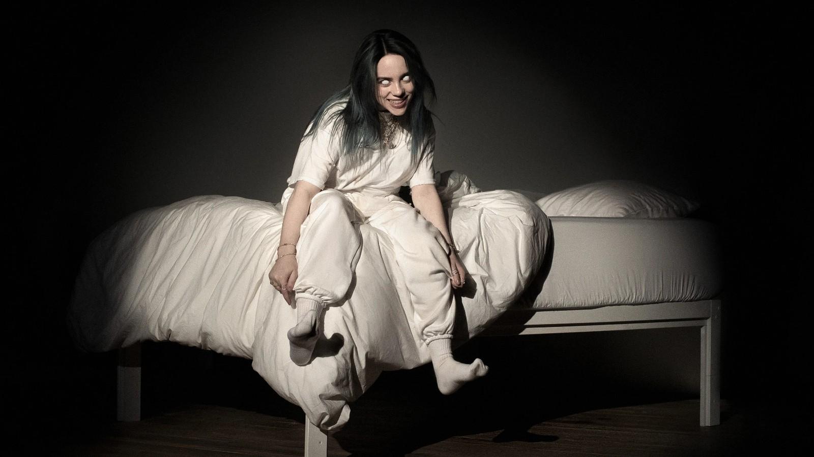 Billie Eilish sitting on a bed on the 'Bury a Friend' cover.