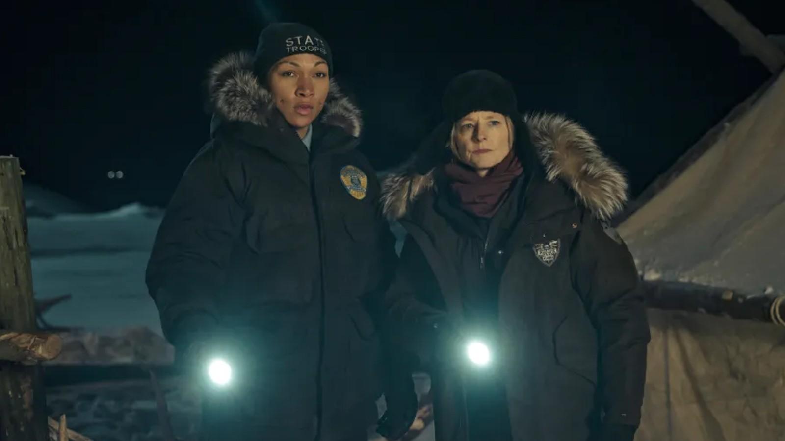 Kali Reis and Jodie Foster as detectives holding torches in True Detective Season 4.