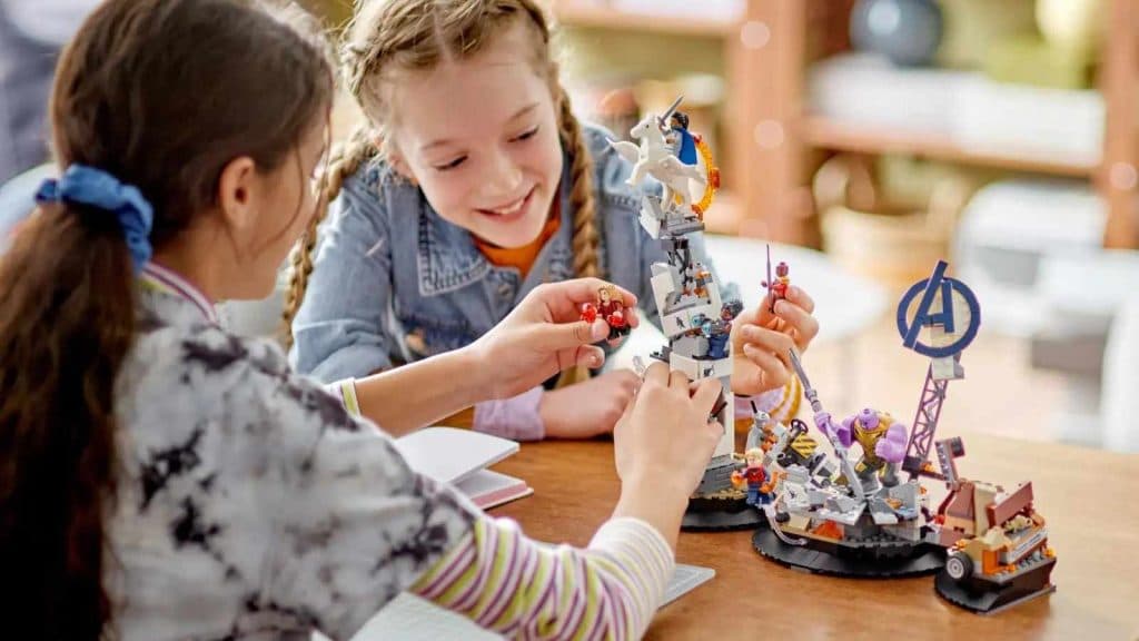 Two children playing with the LEGO Marvel Endgame Final Battle kit