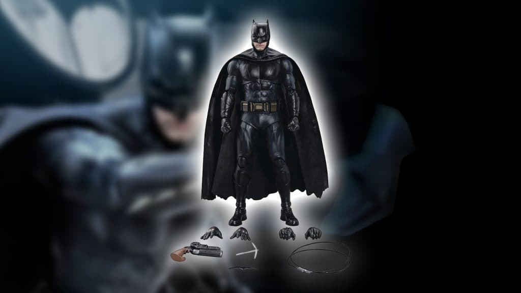 batman action figure on blurry background with tools and spare hands out in front of him