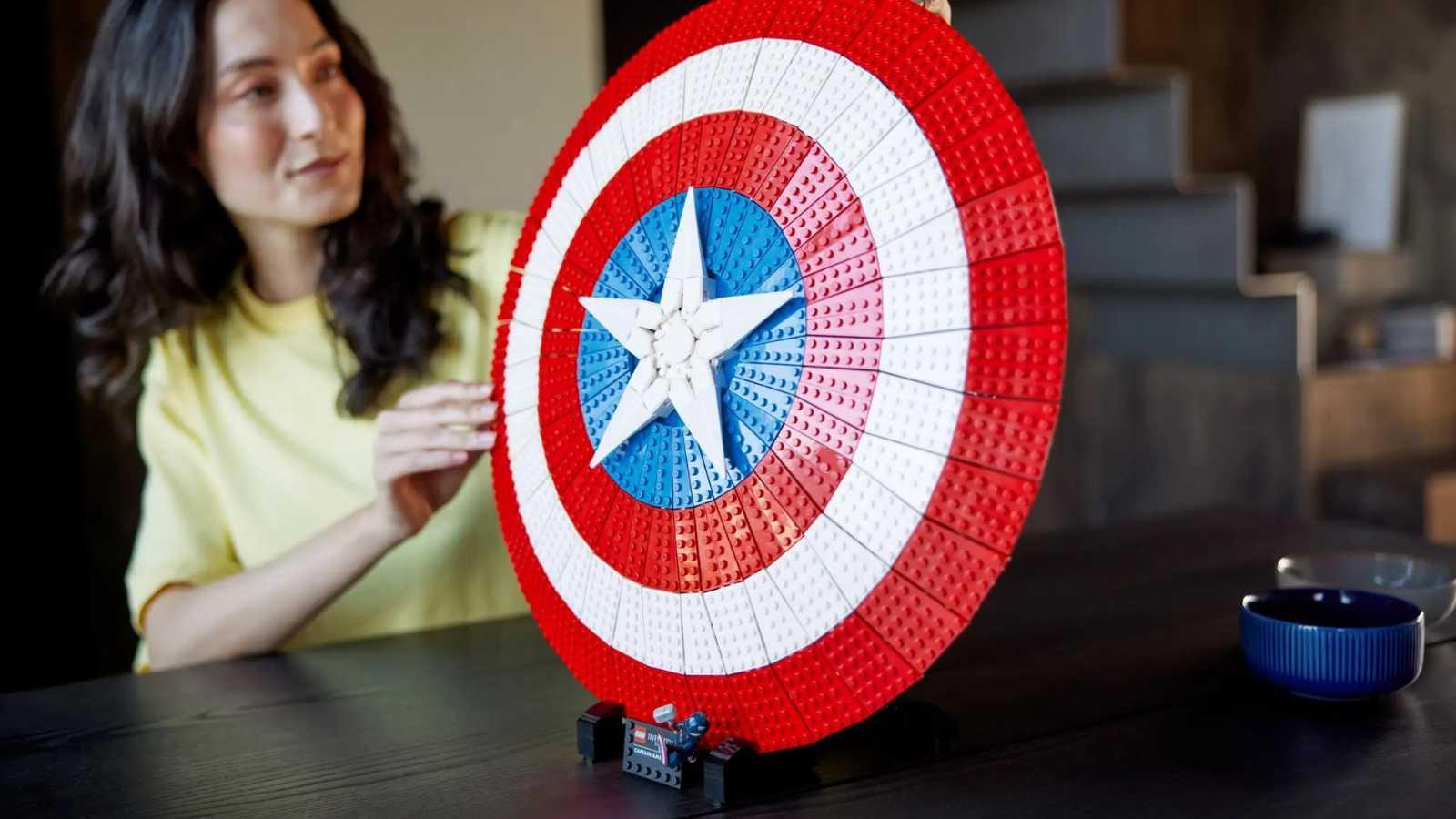 An adult admiring their LEGO Marvel Captain America's Shield set
