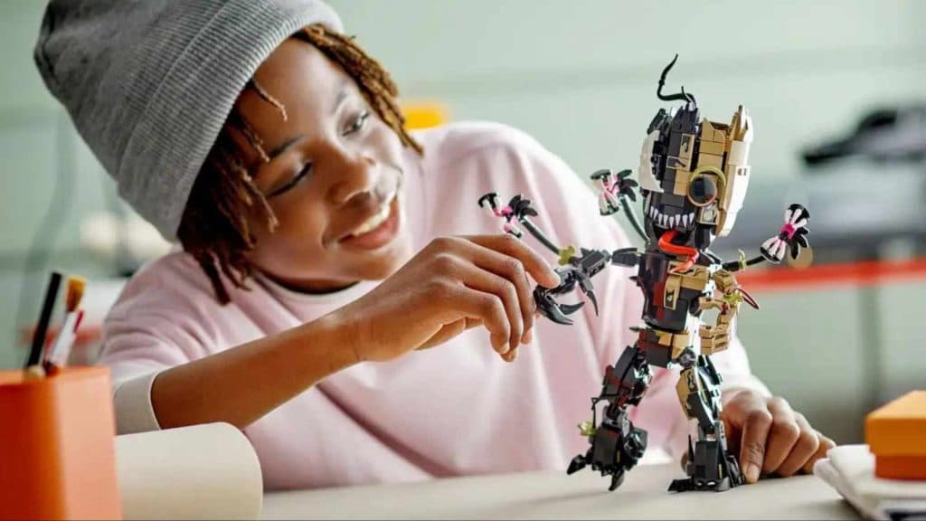 A child playing with their LEGO Marvel Venomized Groot set