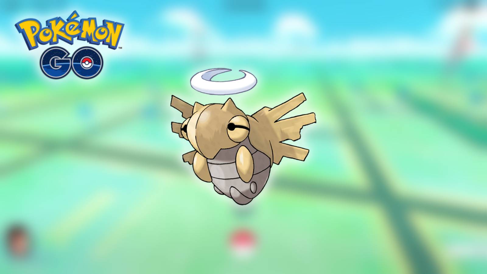 The Pokemon Shedinja appears against a blurred background