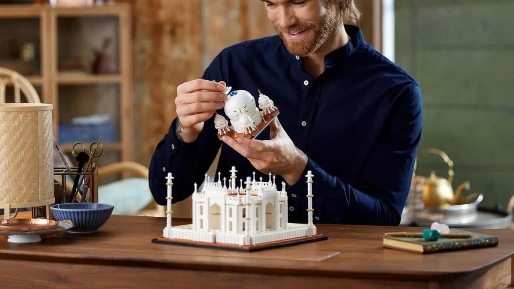 An adult building their LEGO Architecture Taj Mahal set