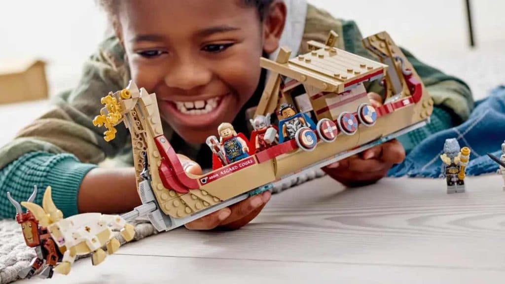 A child playing with their LEGO Marvel The Goat Boat