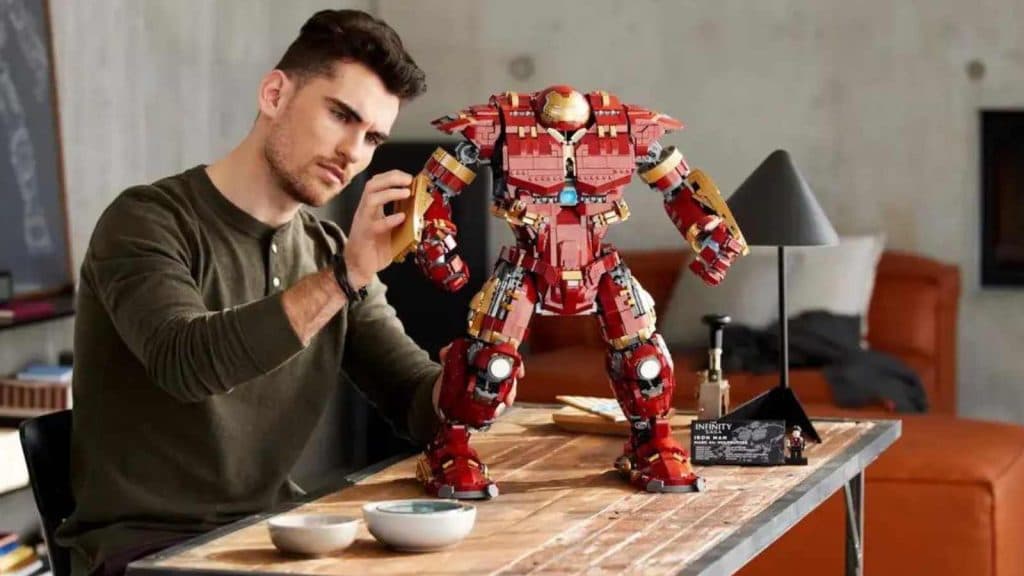 An adult with their LEGO Marvel Hulkbuster set